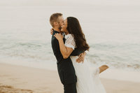 man & woman kissing on rocks