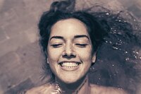 Serene floating woman in grayscale, representing trust, subconscious healing, and the release of emotional weight