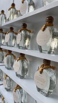 Custom engraved liquor bottles on white shelves