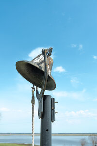 A bell with the sky in the background at Cousiac Manor in Richmond, Virginia.