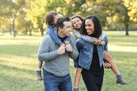 A family is having fun in a park while capturing beautiful memories at an Austin photo studio.