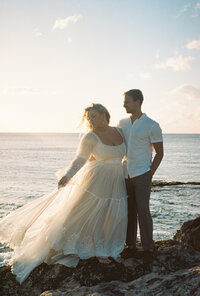 bride and groom hold each other close in Hawaii