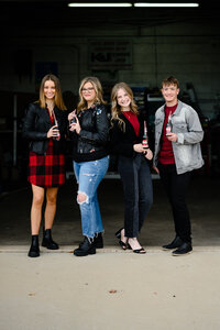 senior picture for high school re team for denver senior photographer with the youths standing together in edgy leather jackets in a garage for an urban styled photo shoot