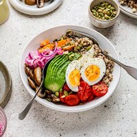 Rainbow Menopause Abundance Bowl featuring quinoa, soft-boiled eggs, avocado, roasted sweet potato, mushrooms, cherry tomatoes, pickled red onion and pumpkin seeds — a balanced midlife recipe from Menopause.Rescripted.