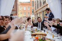 a bride and groom raise a glass during their Lancaster City elopement.