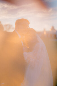 Bride and groom posing on the beach for portraits at Cape May wedding