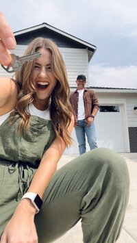 Couple in front of house