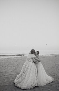 A newlywed couple kissing on the beach 