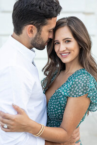 Couple smiling in engagement photo at museum