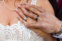 bride and groom with their wedding rings