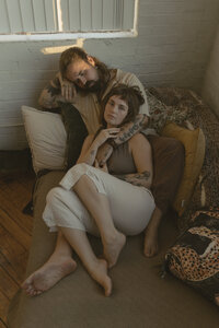 Intimate in-house couples session cuddling in their couch