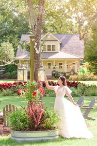 A bride touches the hoisted lanterns at this Charlotte wedding venue.