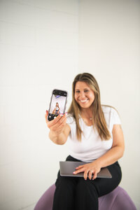 Small business owner planning social media content with assistant