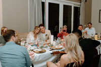 couple getting serenaded at dinner