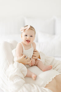 Classic photo of baby with mother in natural timeless studio setting