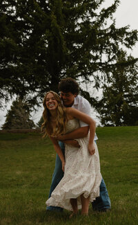 A man gently holding the neck of his girlfriend as he is about to kiss her.