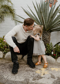 daughter kissing dad in the desert
