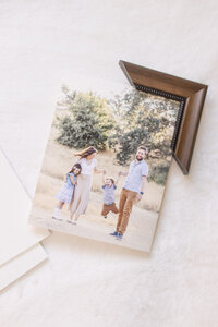 Family portrait mounted print displayed with corner frame sample during client design consultation