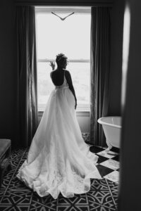 Wedding Photography, black and white image of bridge standing next to a window