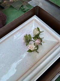 brides light pink wedding flowers preserved in a square resin block