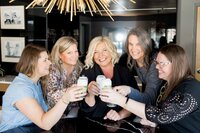 a group of women clinking their drinks