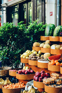 A vibrant fruit stand overflowing with a variety of fresh fruits, including apples, bananas, and oranges.