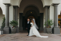 A motion-blur photograph of bride and groom captured by California documentary wedding photographer.