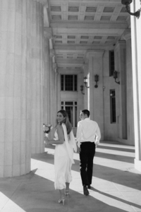 Black and white image of newlywed couple in non-traditional wedding clothes at a historical stone wedding venue | SushDigitalMedia