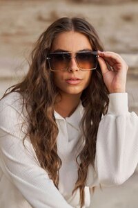 Editorial photograph of a blond model wearing Butterscotch  St Tropez Vieux Sunglasses
