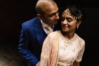 Indian bride and groom hugging at Leeds Civic Hall