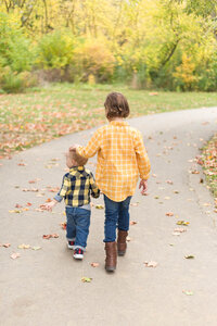 Brother and sister walking on trail portrait