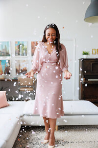 Dee smiling in confetti