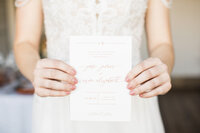 bride holding wedding invitation