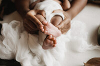 mom holding baby's feet
