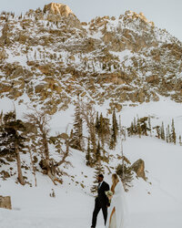 bride and groom in snowy mountains
