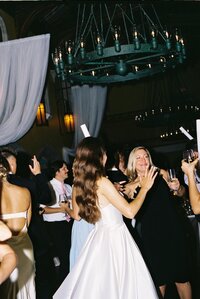 happy young couple kissing, sitting on stairs at destination wedding after ceremony