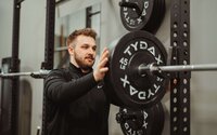 Individual performing guided mobility and strength exercises with therapist support