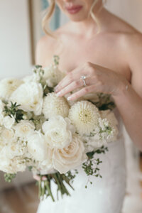 Bride holding her bridal flowers in wedding dress