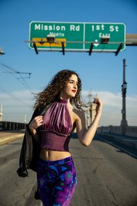 teen girl in stylish outfit walking in the streets of downtown Los Angeles for her senior portraits in Southern California