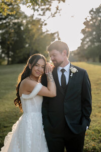 A man and woman slow dance in the middle of a museum, surrounded by ancient pots and other sculptures.