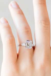 close-up of diamond engagement ring on finger