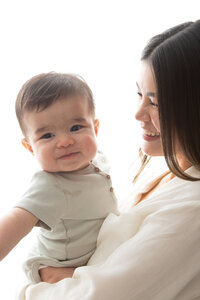 Edmonton back lit studio portrait of mom holding baby boy