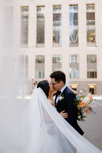 Bride and groom kissing in downtown Chicago