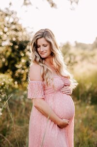 Pregnant woman in blue flowing dress at a Maternity session in Orlando, FL
