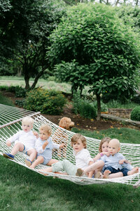 Family of five walks on a dock at their home
