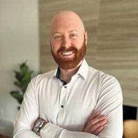 bald man with red beard smiling