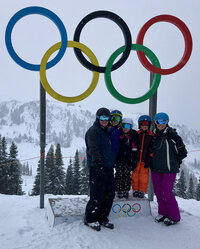 Family posing in front of olympic rings in Whistler, BC, Canada