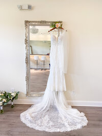 Wedding dress hanging from a mirror