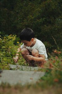 Happy young boy playing outdoors at an East Dallas preschool offering parent workshops and early childhood education programs in Dallas, TX.