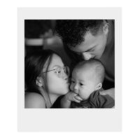 A photo of Cindy and her husband kissing their son on the head.
